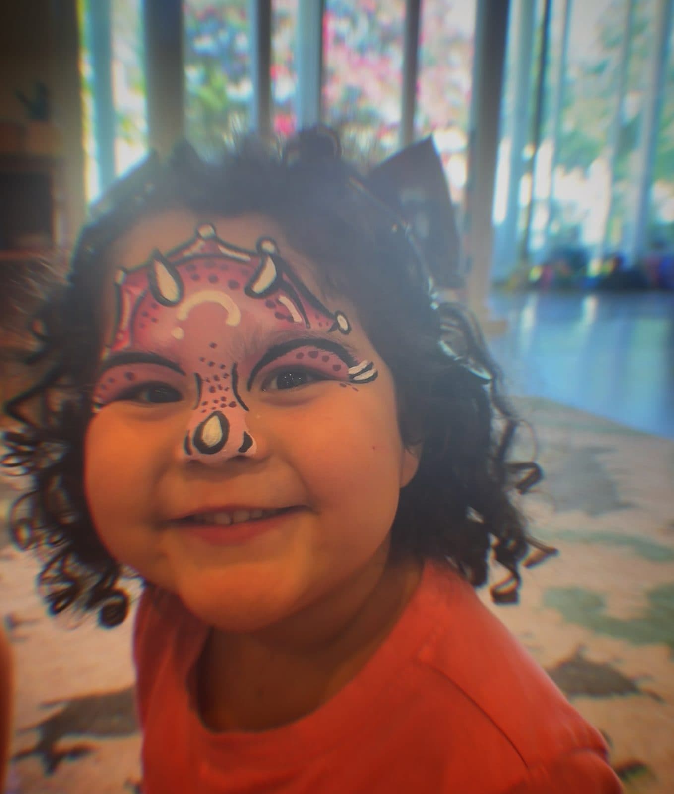 Girl smiling with cat face paint